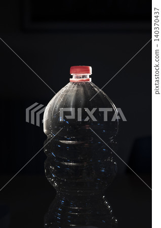 Plastic Water Bottle on Dark Background Plastic Water Bottle on Dark Background 140370437