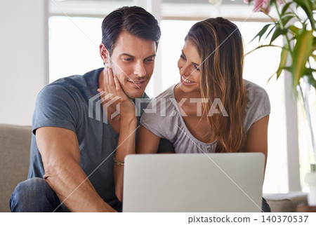Couple, home and laptop for entertainment, smile and love for embrace and affection on sofa in lounge. Man, woman and sit with girlfriend, tech and computer in living room to relax and be happy Couple, home and laptop for entertainment, smile and love for embrace and affection on sofa in lounge. Man, woman and sit with girlfriend, tech and computer in living room to relax and be happy 140370537