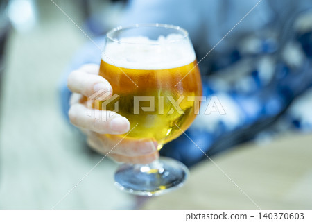 A woman holding a beer glass 140370603