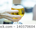 A woman holding a beer glass 140370604