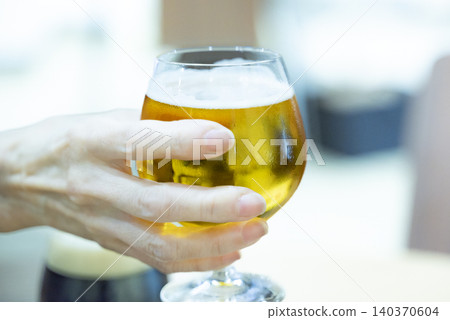 A woman holding a beer glass 140370604