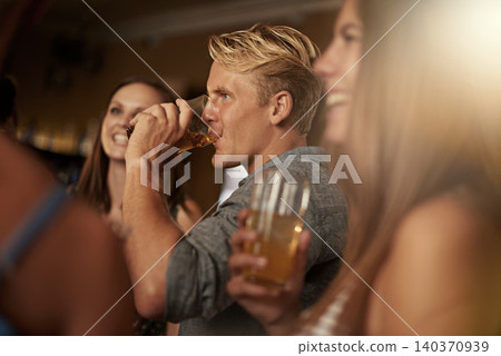 Friends, man and happiness in pub with beer for happy hour, relax or social event with window view. Diversity, people and drinking alcohol in restaurant or club with smile for bonding and celebration Friends, man and happiness in pub with beer for happy hour, relax or social event with window view. Diversity, people and drinking alcohol in restaurant or club with smile for bonding and celebration 140370939