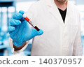 Scientist Holding Ebola Virus Positive Blood Sample Tube 140370957