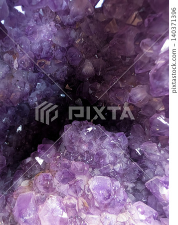 Close-up background image of a mystical amethyst crystal / Natural mineral image that evokes a sense of healing and luxury. Close-up background image of a mystical amethyst crystal / Natural mineral image that evokes a sense of healing and luxury. 140371396