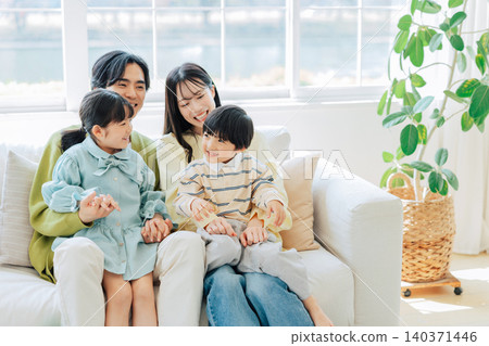 A family relaxing in a bright living room A family relaxing in a bright living room 140371446