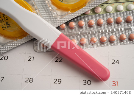 Pregnancy test and birth control pills on calendar, contraception health and medicine. Pregnancy test and birth control pills on calendar, contraception health and medicine. 140371468