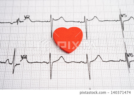 Red heart on electrocardiogram ECG with red heart, heart wave, heart attack, cardiogram report. Red heart on electrocardiogram ECG with red heart, heart wave, heart attack, cardiogram report. 140371474