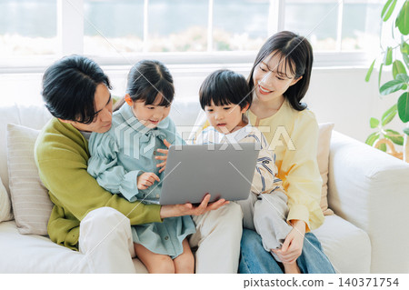 Family watching computer on the sofa 140371754