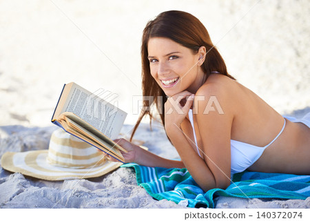 Beach, portrait and woman reading book to relax in summer on towel, sand and outdoor in nature. Girl, smile and happiness in bikini at sea, vacation and hat for sun, weekend and novel for person Beach, portrait and woman reading book to relax in summer on towel, sand and outdoor in nature. Girl, smile and happiness in bikini at sea, vacation and hat for sun, weekend and novel for person 140372074