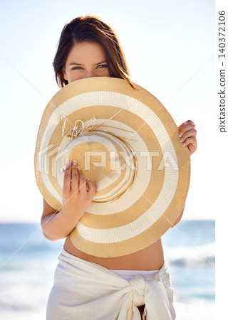 Woman, portrait and hat on beach for travel, holiday and vacation in Maldives in summer with relax and confidence. Person, tourist and face with beachwear outdoor in nature for adventure and getaway Woman, portrait and hat on beach for travel, holiday and vacation in Maldives in summer with relax and confidence. Person, tourist and face with beachwear outdoor in nature for adventure and getaway 140372106