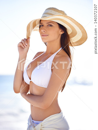 Woman, portrait and smile on beach with hat in summer for travel, holiday or vacation in Maldives with relax. Person, tourist and face with bikini or happy outdoor in nature for adventure or getaway Woman, portrait and smile on beach with hat in summer for travel, holiday or vacation in Maldives with relax. Person, tourist and face with bikini or happy outdoor in nature for adventure or getaway 140372107