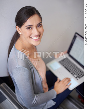 Research, portrait or happy woman on steps with laptop for online course or learning in university. Education, smile or proud female college student with technology for news, project or web design 140372127