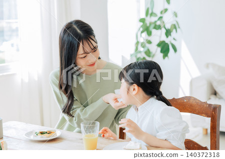 A family eating in a bright dining room A family eating in a bright dining room 140372318