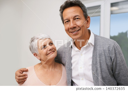 Portrait, senior or happy couple hug in lounge at home for bonding together with support, pride or smile. Retirement, people or romantic man by an elderly woman for peace, love or care in marriage Portrait, senior or happy couple hug in lounge at home for bonding together with support, pride or smile. Retirement, people or romantic man by an elderly woman for peace, love or care in marriage 140372635