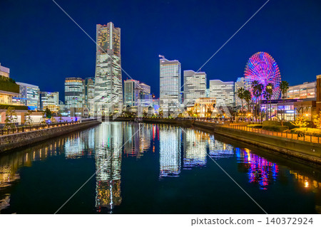 Minato Mirai's entire complex illuminates on Christmas Eve. The water reflection and windmill-shaped night view from Bankoku Bridge. Minato Mirai's entire complex illuminates on Christmas Eve. The water reflection and windmill-shaped night view from Bankoku Bridge. 140372924
