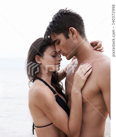 Love, beach and couple hugging on vacation, adventure or holiday together for tropical travel. Nature, summer and young man and woman embracing with care on romantic date on weekend island trip. Love, beach and couple hugging on vacation, adventure or holiday together for tropical travel. Nature, summer and young man and woman embracing with care on romantic date on weekend island trip. 140372998