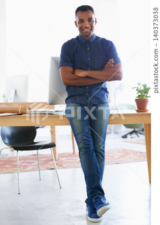 Arms crossed, smile and portrait of man by desk in office for vision, web design or startup company. Happy, confident and creative person by table with technology for entrepreneur, research or pride Arms crossed, smile and portrait of man by desk in office for vision, web design or startup company. Happy, confident and creative person by table with technology for entrepreneur, research or pride 140373038