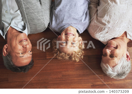 Portrait, grandparents and boy on the wooden floor or bonding together with vacation or apartment. Family, face or elderly man with old woman, grandkid or child with fun or cheerful with home or love Portrait, grandparents and boy on the wooden floor or bonding together with vacation or apartment. Family, face or elderly man with old woman, grandkid or child with fun or cheerful with home or love 140373209