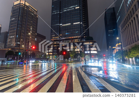 The streets of Marunouchi in front of Tokyo Station on a rainy night The streets of Marunouchi in front of Tokyo Station on a rainy night 140373281