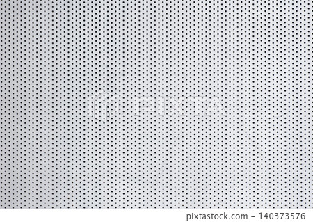 A silver metal plate with countless tiny round holes arranged in a regular pattern. A silver metal plate with countless tiny round holes arranged in a regular pattern. 140373576