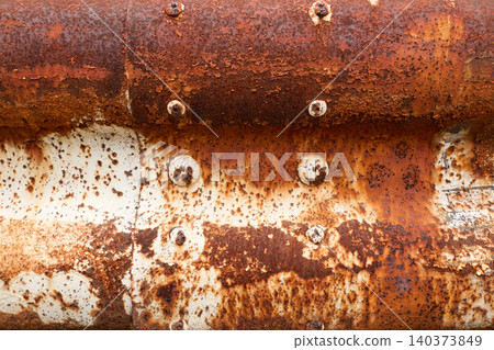 The surface of an old metal guardrail, severely rusted due to years of deterioration. The surface of an old metal guardrail, severely rusted due to years of deterioration. 140373849