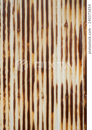 A close-up of old corrugated iron sheets that have rusted brown due to years of deterioration. A close-up of old corrugated iron sheets that have rusted brown due to years of deterioration. 140373854