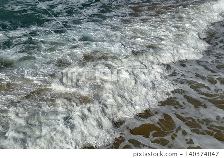 Aerial Shot of White Foam Wave Lines on Shallow Green Ocean Water by Jetty 140374047