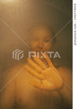 Woman Touching Foggy Shower Glass in Bathroom Scene Woman Touching Foggy Shower Glass in Bathroom Scene 140374058