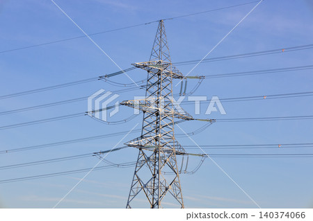 Electricity transmission pylon with power lines 140374066