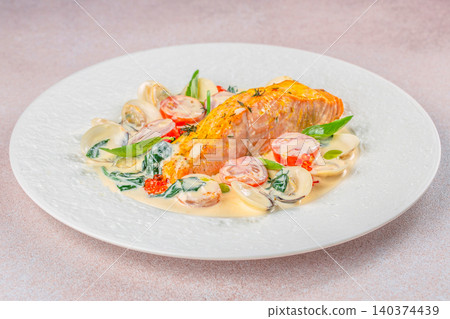 Pan seared salmon with clams spinach and creamy sauce in gourmet restaurant style Pan seared salmon with clams spinach and creamy sauce in gourmet restaurant style 140374439