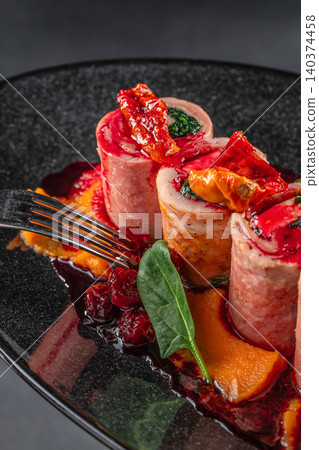 Pork roulades with cranberry sauce and pumpkin puree Pork roulades with cranberry sauce and pumpkin puree 140374458