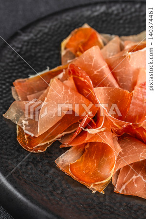 Close Up of Spanish Jamon Slices on Black Ceramic Plate Close Up of Spanish Jamon Slices on Black Ceramic Plate 140374461
