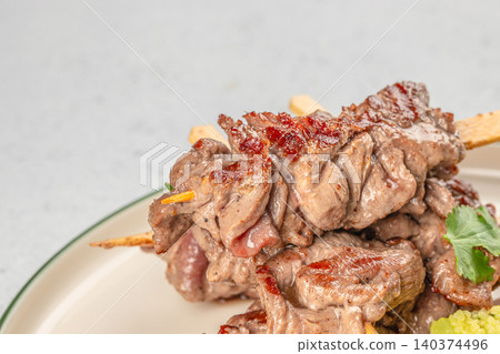 Juicy grilled beef skewers close up in gourmet restaurant style presentation 140374496