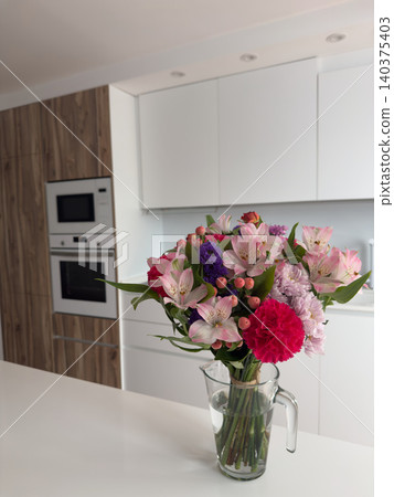 Vibrant Flower Arrangement Glass Vase Modern White Kitchen Island Interior Decor Vibrant Flower Arrangement Glass Vase Modern White Kitchen Island Interior Decor 140375403