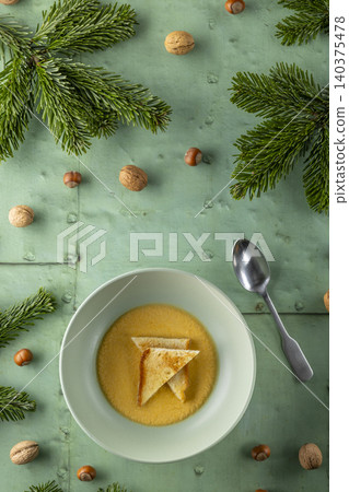 Warm winter soup with toast and fir branches Warm winter soup with toast and fir branches 140375478