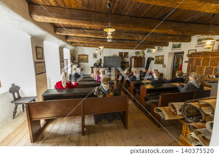 Traditional classroom scene with teacher and student mannequins 140375520