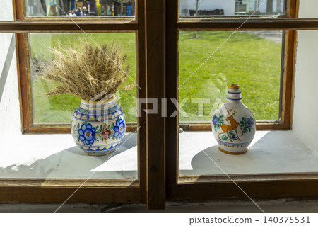 Rural window sill displaying traditional Czech ceramic vases Rural window sill displaying traditional Czech ceramic vases 140375531