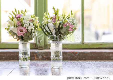 Wedding flower bouquets decorating old green window sill Wedding flower bouquets decorating old green window sill 140375559