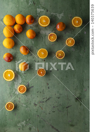 Fresh oranges and blood oranges on rustic green wood 140375639