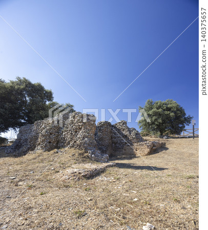 Ancient stone ruins standing under a clear blue sky Ancient stone ruins standing under a clear blue sky 140375657