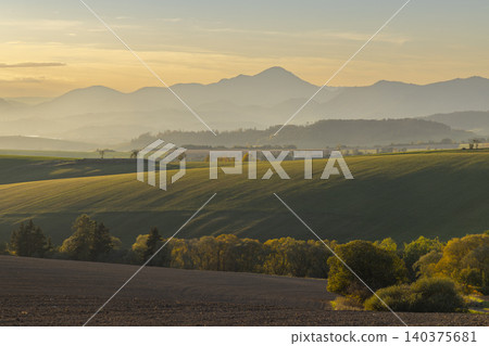 Rural fields and rolling mountains at sunrise in Slovakia Rural fields and rolling mountains at sunrise in Slovakia 140375681
