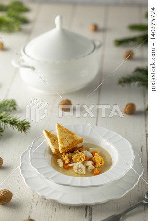 Warming fish soup with croutons and walnuts Warming fish soup with croutons and walnuts 140375724