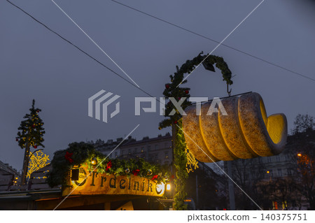 Trdelnik sign glowing at Prague Christmas market Trdelnik sign glowing at Prague Christmas market 140375751