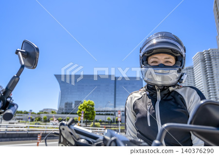 A female rider smiles in Minato Mirai. A female rider smiles in Minato Mirai. 140376290