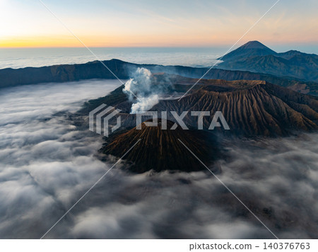 Amazing Mount Bromo volcano during sunrise from king kong viewpoint on Mountain Penanjakan in Bromo Tengger Semeru National Park,East Java,Indonesia.Nature landscape background Amazing Mount Bromo volcano during sunrise from king kong viewpoint on Mountain Penanjakan in Bromo Tengger Semeru National Park,East Java,Indonesia.Nature landscape background 140376763