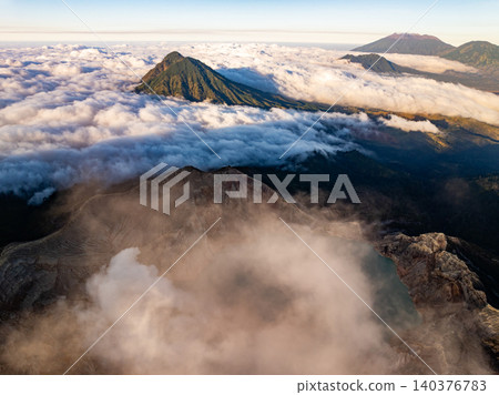 Aerial view of rock cliff at Kawah Ijen volcano with turquoise sulfur water lake at sunrise.Amazing nature landscape view at East Java, Indonesia. Natural landscape background 140376783