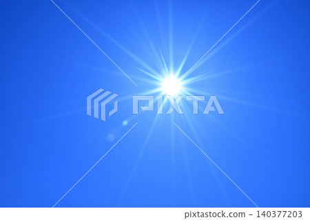 Blue sky and sun, direct sunlight, free space image 140377203