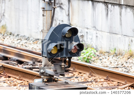 A close-up of a railway shunting signal and rails installed beside the tracks. A close-up of a railway shunting signal and rails installed beside the tracks. 140377206