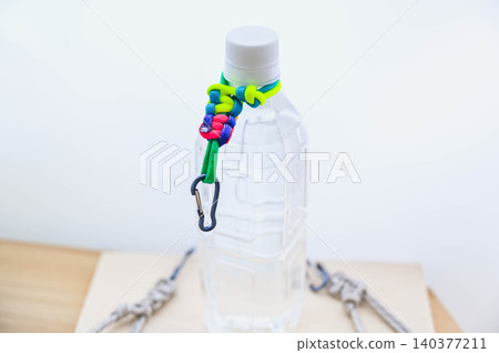 Handmade water bottle holder made from paracord 140377211