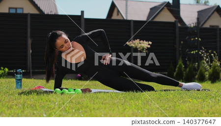 Young woman doing sports at nature, Female fitness training in sportswear. Sport, fitness, health and lifestyle concept. Young woman doing sports at nature, Female fitness training in sportswear. Sport, fitness, health and lifestyle concept. 140377647